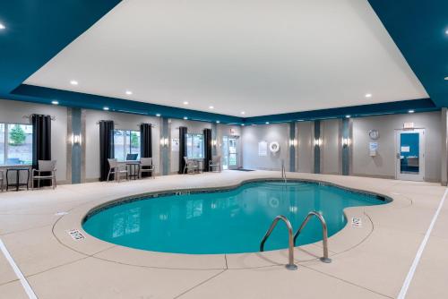 a large swimming pool in a hotel room with a large pool at Holiday Inn Express & Suites - Charlotte Airport, an IHG Hotel in Charlotte