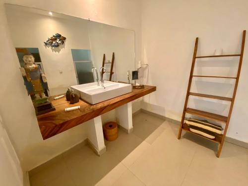 a bathroom with a sink and a mirror at La Bella - Hotel Villa & Spa in Gili Trawangan