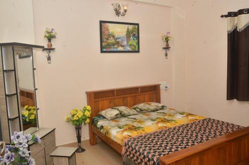 a bedroom with a bed in a room at Sri Vana Durga Service Apartment in Sringeri