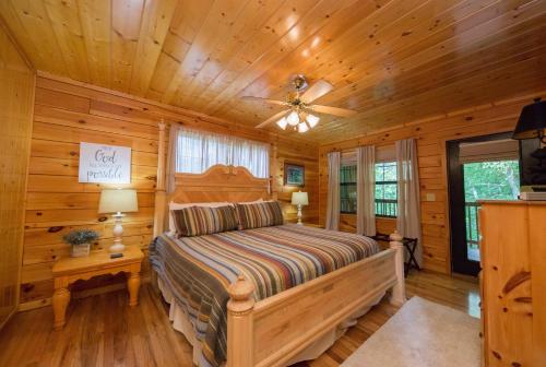 a bedroom with a bed in a log cabin at Drift Away Cabin in Sevierville