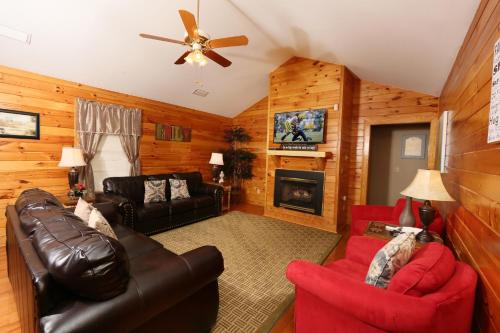 a living room with leather furniture and a fireplace at Three-Bedroom Apartment in Pigeon Forge
