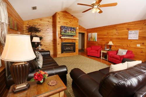 a living room with leather furniture and a fireplace at Three-Bedroom Apartment in Pigeon Forge