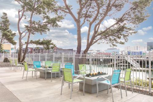 a row of tables and chairs on a patio at Holiday Inn Express Hotel & Suites Seaside Convention Center by IHG in Seaside