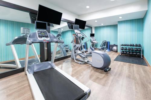 a gym with treadmills and cardio equipment in a room at Holiday Inn Express Hotel & Suites Seaside Convention Center by IHG in Seaside