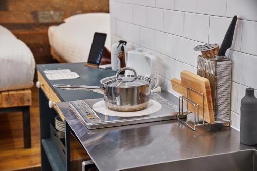 a tea pot sitting on a stove in a kitchen at mizuka Imaizumi 1 - unmanned hotel - in Fukuoka