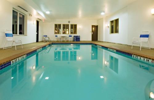 a large swimming pool with blue water in a building at Holiday Inn Express Childress, an IHG Hotel in Childress