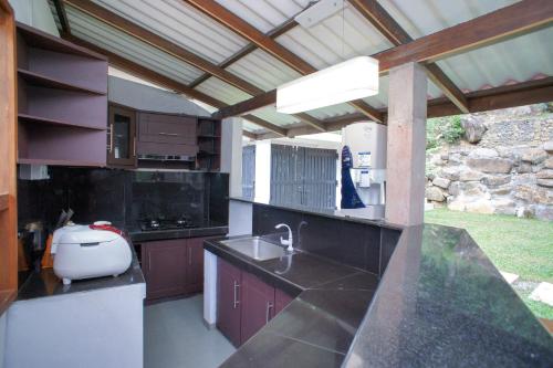 a kitchen with a sink and a counter top at Pineview in Unawatuna