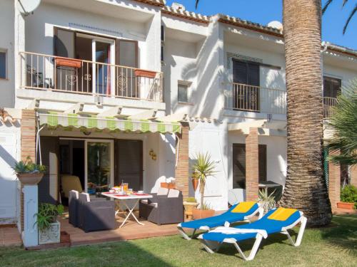 a house with chairs and a table in the yard at Holiday Home La Aldea by Interhome in Denia