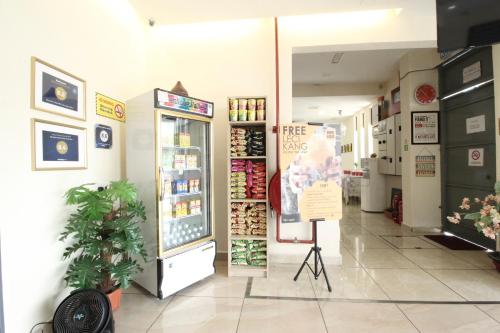 a grocery store with a display case in a room at Mimilala Hotel @ i-City, Shah Alam in Shah Alam