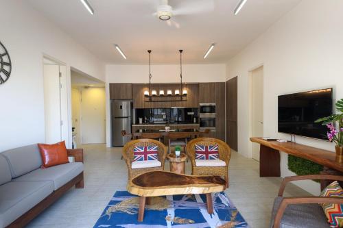 a living room with a couch and a table at By The Sea Beach Front Apartment in Batu Ferringhi
