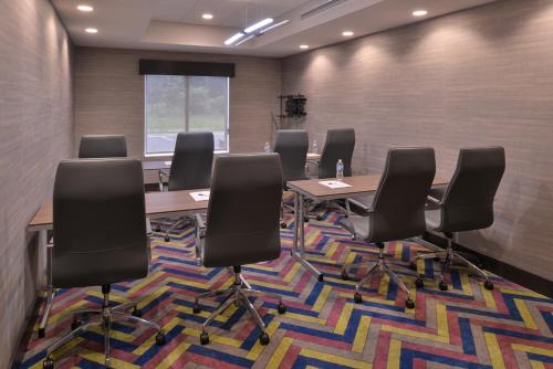 a conference room with chairs and tables on a rug at Holiday Inn Express and Suites Bryant - Benton Area by IHG in Bryant
