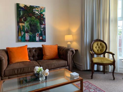 a living room with a brown couch and a chair at Beach house in Crosby