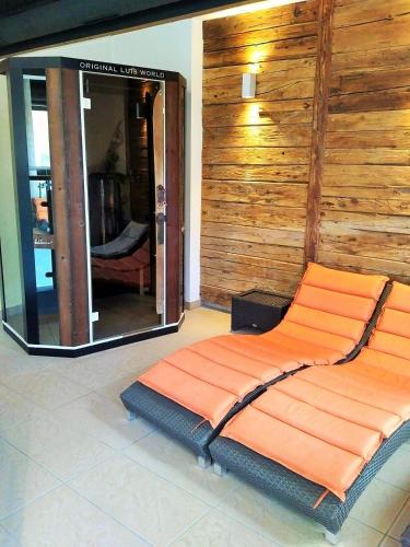 a bed in a room with a mirror at Schönblick Mountain Resort & Spa - Das Original! in Rauris