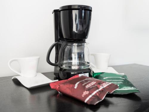 a blender sitting on a table with a bag of chips at Suites Arboleda 215 in Mexico City