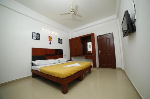 Voodi või voodid majutusasutuse Kairali Tourist Home toas
