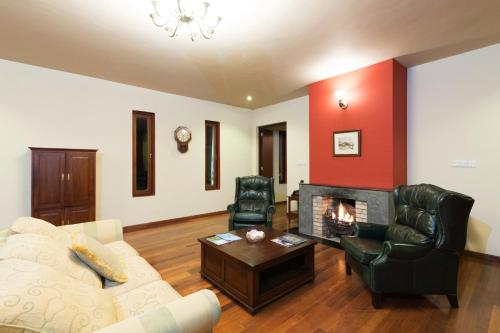 a living room with a couch and a fireplace at The Walden Nuwara Eliya in Nuwara Eliya
