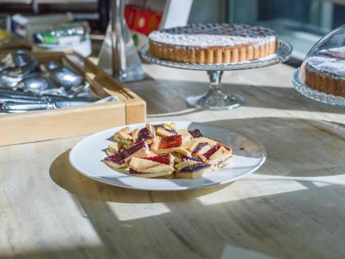 a plate of food on a table with two cakes at Grand Hotel Tiziano E Dei Congressi in Lecce