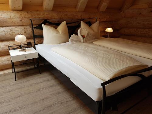 a bedroom with two beds in a log cabin at LakeStarnberg in Pöcking