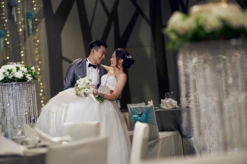 a bride and groom standing in front of a table at Crowne Plaza Changi Airport by IHG in Singapore