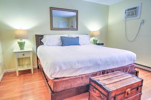 a bedroom with a large bed with a mirror on the wall at East Shore Lodging in Hawley