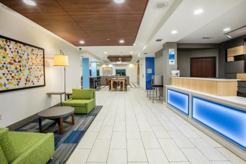 a lobby of a hospital with chairs and a bar at Holiday Inn Express Hotel & Suites Dallas - Grand Prairie I-20 by IHG in Grand Prairie