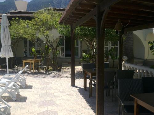 a patio with a table and chairs and a umbrella at Club Alda in Lapithos