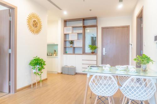a dining room with a table and two chairs at Vinhome Skylake 2 in Hanoi