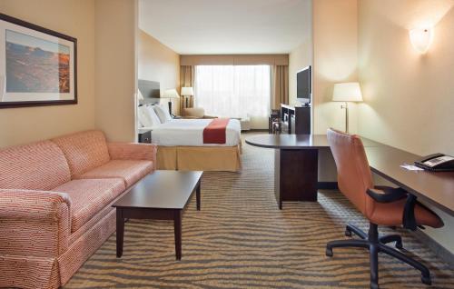 a hotel room with a bed and a desk at Holiday Inn Express & Suites Gallup East by IHG in Gallup