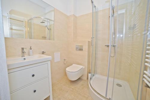 a bathroom with a shower and a toilet and a sink at Aparment near Monte Cassino by Grand Apartments in Sopot