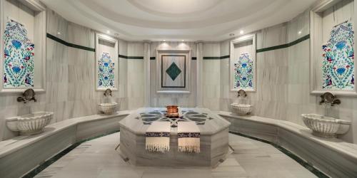 a bathroom with four sinks in a room with windows at Merit Lefkosa Hotel & Casino in North Nicosia