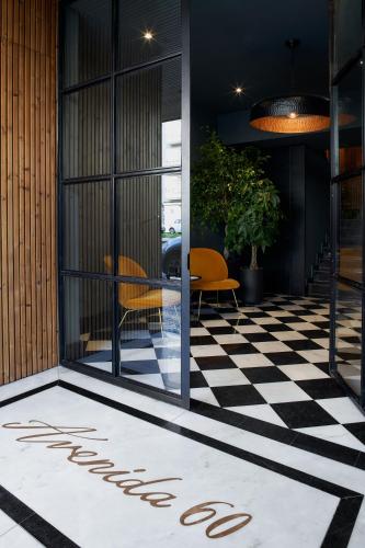 a lobby with a checkered floor and a sign that says welcome at Nôma Living Avenida 60 in Aveiro