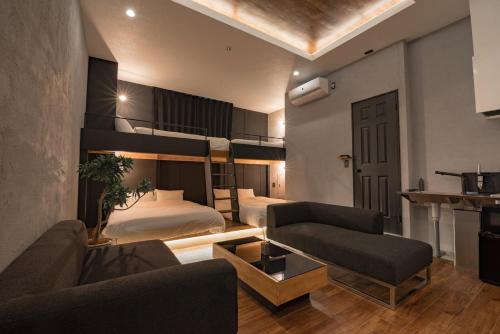 a bedroom with a bunk bed and a living room at mizuka Imaizumi 2 - unmanned hotel - in Fukuoka