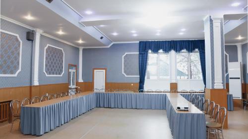 a room with a row of chairs and a table at Aktobe Hotel in Aktobe