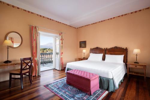 En eller flere senge i et værelse på Sina Villa Matilde