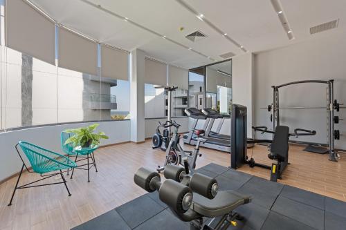 a fitness room with a gym with exercise equipment at Sunset Beach Resort and Spa in Phu Quoc