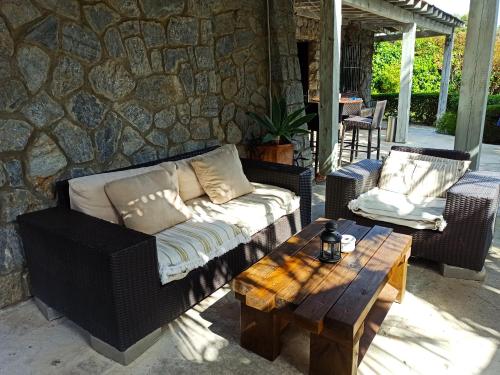 a couch and a coffee table on a patio at Hostal Boutique Los Geranios del Pinar in Torremolinos