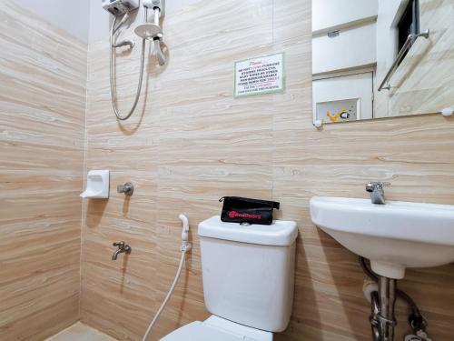 a bathroom with a toilet and a sink at RedDoorz near Gaisano Mall Gensan in General Santos