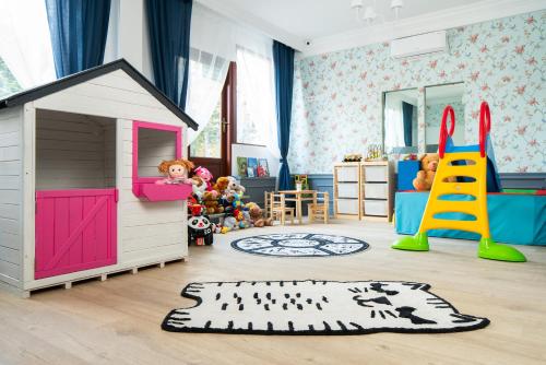 a childs room with a play area with a toy house at Grand Chotowa Hotel Spa & Resort in Chotowa
