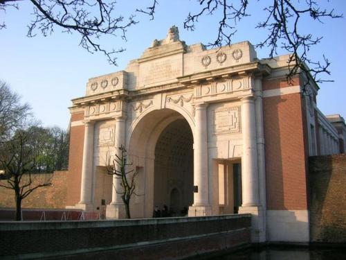 a large building with an arch in front of it at LE CHAT NOIR in Ypres