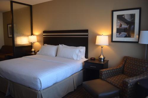 a hotel room with a bed and a chair at Holiday Inn Express & Suites Golden by IHG in Golden