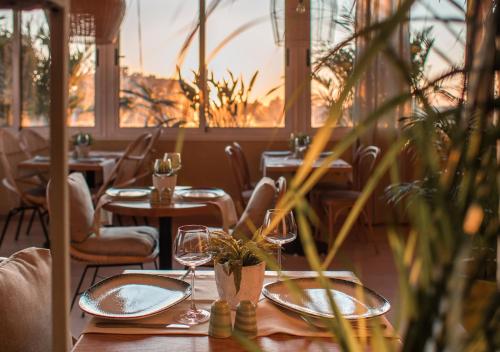 a restaurant with tables and chairs with glasses on them at The President Hotel Cairo in Cairo