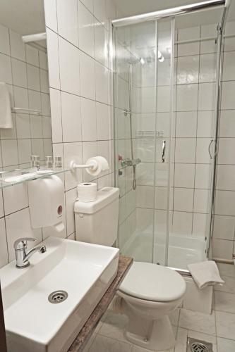 a bathroom with a toilet and a shower and a sink at Anna Panzió & Wellness Siófok in Siófok