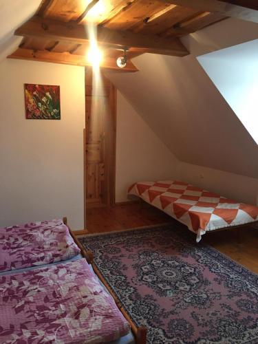 a bedroom with two beds in a attic at Agro privat in Hrabušice