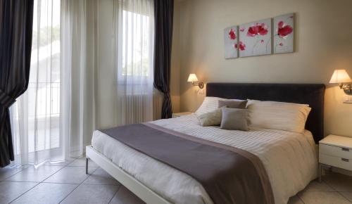 una camera da letto con un grande letto con fiori rossi sul muro di Residence Hamilton a Riccione