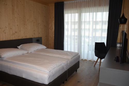 Postel nebo postele na pokoji v ubytování GästeHAUS & HOFladen Familie Öllerer