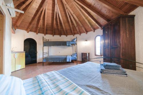 a bedroom with a large bed in a room at Tsolis Village in Lambírion