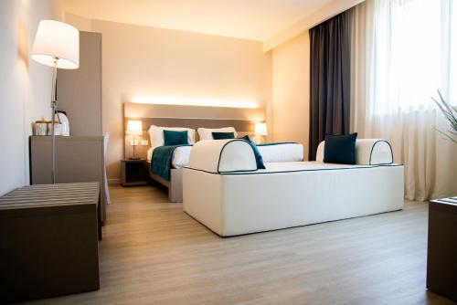Postel nebo postele na pokoji v ubytování Hotel Glis