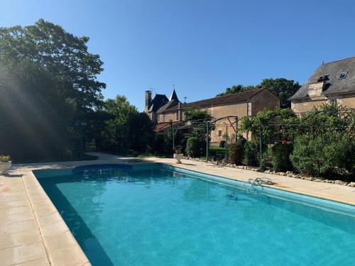 a large blue swimming pool in front of a house at Ch&acirc;teau d'Avanton in Avanton