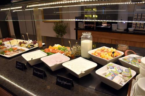 a buffet of food on a counter in a restaurant at Ferienhotel Wolfsmühle in Rodishain