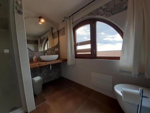 a bathroom with a sink and a window at Casa Ombrina in Orosei